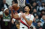 Portland Trail Blazers guard Shaedon Sharpe, right, shoots over Minnesota Timberwolves forward Jaden McDaniels during the first half of an NBA basketball game in Portland, Ore., Wednesday, Nov. 13, 2024.