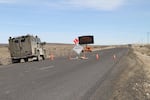 A camouflage truck crosses the road block into the Malheur National Wildlife Refuge Sunday, Feb. 7, 2016.