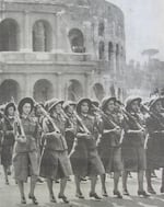 Young women in military-style uniforms with guns, members of the Giovane Italiane (Young Italians) fascist youth group, pictured marching in Rome, circa 1935