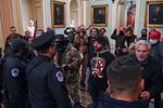 Douglas Jensen and other rioters speaking to U.S. Capitol Police in the U.S. Capitol on Jan. 6, 2021. Jensen later told the FBI he had worn the QAnon shirt and put himself at the front of the crowd because he "wanted Q to get the attention."