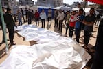 People surround the bodies of Palestinians killed in an Israeli strike in front of the Indonesian hospital in Beit Lahia in the northern Gaza Strip, on Friday.