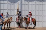 Members of the visiting court wait on the sidelines. The St. Paul Rodeo welcomes title holders such as rodeo queens from other rodeos near and far.