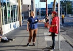 Julie Showers hands out cool water outside Blanchet House in downtown Portland, Aug. 22, 2025.