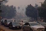 People evacuate on Sunset Boulevard from the Palisades Fire on Jan. 7, 2025 in the Pacific Palisades neighborhood of Los Angeles, Calif.