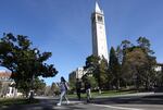 People walk by Sather Tower on the UC Berkeley campus on March 14, 2022 in Berkeley, California.