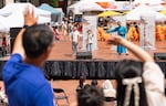 Xi Chen, right, a Beaverton School District substitute teacher, and a group from the Voice of Civic Engagement Award performs on stage, while other members of the act perform in the crowd at the Oregon Chinese Coalition’s Chinese Festival in Pioneer Courthouse Square in Portland, Ore., on Aug. 1, 2026. The Voice of Civic Engagement Award is an annual honor that encourages young people to speak up at public events and in community platforms.