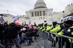 Insurrectionists loyal to President Donald Trump try to break through a police barrier on Jan. 6, 2021, at the Capitol in Washington, D.C.