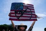 FILE - A protestor holds a sign during a Students Demand Action event, near the U.S. Capitol, Monday, June 6, 2022, in Washington.