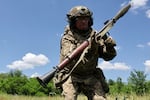 In this photo provided by Ukraine's 65th Mechanized Brigade press service, a soldier practices military skills at a training ground near the frontline in the Zaporizhzhia region, Ukraine, Saturday, June 20, 2026.