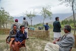Men at a tea house perched over their village of Chunda. They're part of a group that's trying to mate glaciers to create a new glacier baby as human-induced warming rapidly melts the glaciers the residents have traditionally relied on for water. The U.N. is supporting their efforts.