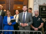 Eric Trump stands in the hallway outside the New York City courtroom where his family's civil fraud case is underway, on Oct. 25.