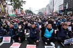 Members of the Korean Confederation of Trade Unions shout slogans during a rally against the government's labor policy near the National Assembly in Seoul on Saturday.