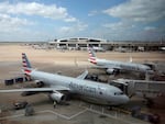 Three Black men have filed a lawsuit against American Airlines saying they were victims of “blatant and egregious racial discrimination” after being removed from a flight. Above, American Airlines planes are seen at Dallas-Fort Worth International Airport in June 2018. 