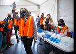 Gov. Kate Brown thanks workers drawing up COVID-19 vaccines as she tours a drive-thru vaccination clinic at Portland International Airport, April 9, 2021. The clinic is a joint operation hosted by Oregon Health & Science University, the Port of Portland and the American Red Cross.