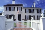 A large home with a white picket fence is at the heart of the mythology around the "American Dream."