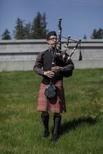 A bagpiper plays on a grassy slope at Campbell's service. With Mount Hood on the horizon, friends and family buried Campbell next her spouse, Nancy Lynchild, who died of cancer six years ago.