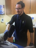 Tyler Cox at his job at Oregon Health & Science University, where he works as a nurse.
