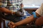 Kenneth Pierson conducts a blood test in the van. The SPOT vans are staffed with nurse practitioners who can draw blood, conduct tests, prescribe medication and provide some primary care.