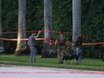 Law enforcement personnel investigate the area around Trump International Golf Club after an apparent assassination attempt of former President Donald Trump on Sunday.