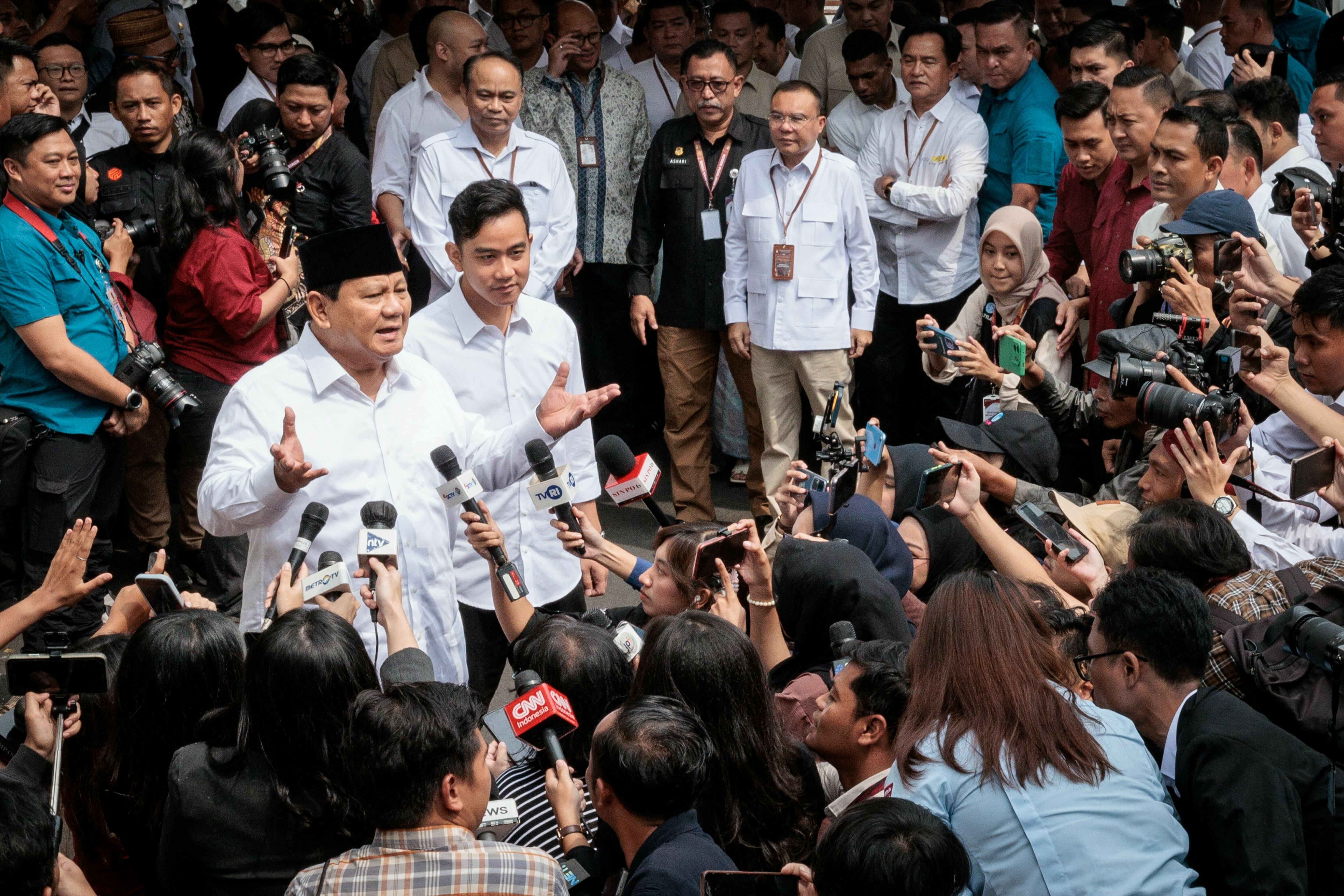 Indonesia's President-elect Prabowo Subianto (left) speaks to reporters with Vice President-elect Gibran Rakabuming Raka (second left) as they arrive at the plenary session of the General Elections Commission after his main rivals' challenges to his election victory were rejected in Jakarta, April 24.