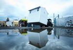 Crews from Pallet move new pods into a homeless camp in Portland, Ore., Wednesday, Dec. 9, 2020. Portland this month assembled neat rows of the shelters, which resemble garden sheds, in three ad-hoc “villages”, part of an unprecedented effort unfolding in cold-weather cities nationwide to keep people without permanent homes safe as temperatures drop and coronavirus cases surge.