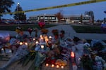 Candles are lit at a makeshift memorial outside Silver Rail Elementary School on Friday, Oct. 16, 2026, Bend, Ore.
