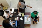 A woman casts her ballot as Turkish citizens residing in Qatar arrive to vote in the second round of Turkey's presidential election, at a polling station in the Turkish Embassy in Doha on May 21.