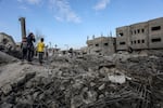 Palestinians inspect destruction after an Israeli bombing of Omar bin Abdul-Aziz Mosque in Rafah, Gaza on January 25, 2024.
