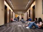 People, including minors, wait outside an immigration courtroom Thursday, July 9, 2026, at the Henry M. Jackson Federal Building in Seattle, Wash. The courtroom this week began so-called "mega master" hearings that speed up immigration hearings for youth pursuing legal status in the U.S.