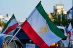 FILE - A caravan of vehicles rides while flying the Lion and Sun flag along Westwood Boulevard, in the so-called "Tehrangeles" neighborhood in the Westwood district of Los Angeles, May 20, 2024.