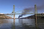 Smoke from an oil train fire is seen beyond the Hood River Bridge in the Columbia River Gorge on Friday, June 3, 2016.