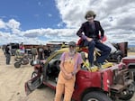 Rick Cafourek leans against his toy gambler while 'The Joker' aka Avery Romine sits on top during the 2026 Gambler 500.