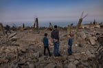 Friends of Amal Hassan al-Durr visit the site where an airstrike took her life.