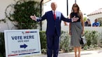 Former President Donald Trump stands with former first lady Melania Trump after voting in 2022.