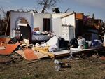 Most walls are gone but furniture remains intact where a home once stood in Rolling Fork, Mississippi.