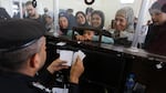 Palestinians with dual nationality register to cross to Egypt on the Gaza Strip side of the border crossing in Rafah on Thursday.