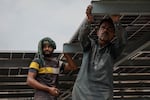 Workers install solar panels on the rooftop of a business on June 30, 2025 in Islamabad, Pakistan.