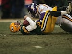 Brett Favre #4 of the Green Bay Packers is tackled by a Minnesota Vikings defensive player during the NFC wild-card game at Lambeau Field on January 9, 2005 in Green Bay, Wisconsin. Favre said Tuesday he's battling Parkinson's disease which comes after a 20-year all-star NFL career where he had numerous concussions.