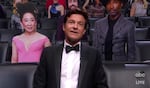 In this video grab captured on Sept. 20, 2020, courtesy of the Academy of Television Arts & Sciences and ABC Entertainment, Jason Bateman appears in the audience surrounded by cardboard cutouts during the 72nd Emmy Awards broadcast. (The Television Academy and ABC Entertainment via AP)