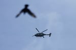 Indian army's helicopter and a bird fly over the sky in Srinagar, Indian controlled Kashmir, Monday, May. 5, 2025. Tensions have soared between the nuclear-armed neighbors over last month’s militant attack on tourists in the Indian-controlled portion of Kashmir. 
