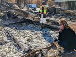 Valerie Linfoot gets down close to the two small piles of ashes in front of her. The remains settled just a couple feet from where Linfoot stored them in her walk-in closet.