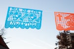 Papel picado flutter overhead at the Día de Muertos celebration in Bend, Ore., on Nov. 7, 2025.