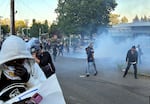 Department of Homeland Security officers deploy crowd control munitions, including tear gas, at a demonstration outside the Portland ICE building on June 14, 2025.