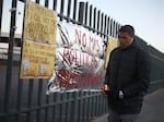 A man holds a candle during a vigil on Tuesday for the victims of a fire at an immigration detention center that killed dozens, in Ciudad Juarez, Mexico. Video footage from inside the facility appears to show officials walking away from men trapped inside a cell as flames roared around them.