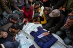 Relatives and friends mourn over the bodies of five Palestinian journalists who were killed by an Israeli airstrike in Gaza City at the Al-Aqsa Hospital in Deir al-Balah, on Thursday.