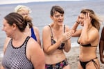 In places like Seattle, the exercise in courage begins on the beach, baring yourself in the brisk air. From left: Colleen Fitzharris, Vivien Sharples, Patty Stevenson, and Alona Ishchenko.