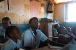Paris Lekuuk, 15, (center) listens to a math lesson in the third grade classroom of his primary school in northern Kenya. Just weeks earlier, he had been living the traditional life of a Samburu "moran," or warrior — herding cattle on a mountain.