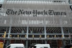 The New York Times says federal agents showed up at several of its journalists' homes Friday night to try to force them to testify before a grand jury next week.