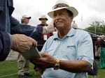 Chi Chi Rodriguez smiles while signing an autograph at the Nashawtuc Country Club in Concord, Mass., on June 9, 2006.