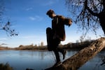 Caleb climbs a tree near his adult foster home on Monday, Nov. 11, 2019, in Oregon. He says this spot on the Willamette River is meditative and important to him because he can't see any man-made buildings or structures from there.